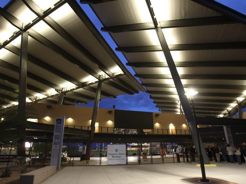 Construction site with steel beams and evening sky.