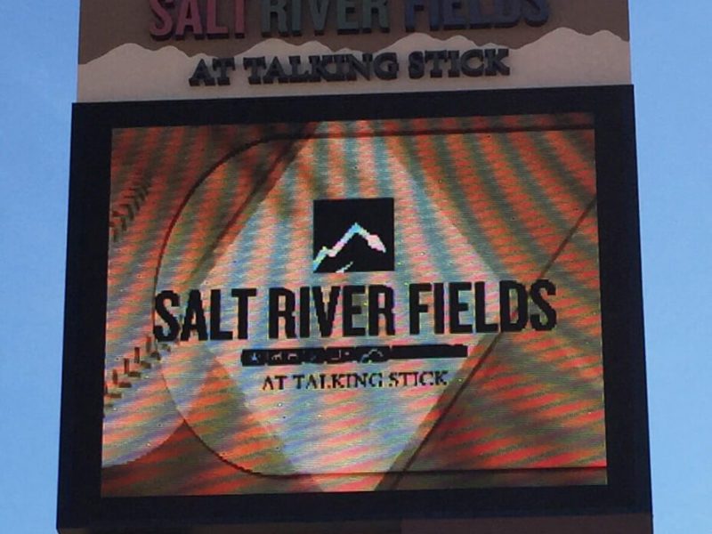 Digital sign for Salt River Fields at Talking Stick under a clear blue sky.