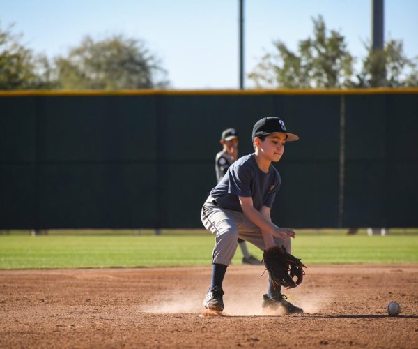 Youth baseball infielder fielding ground ball