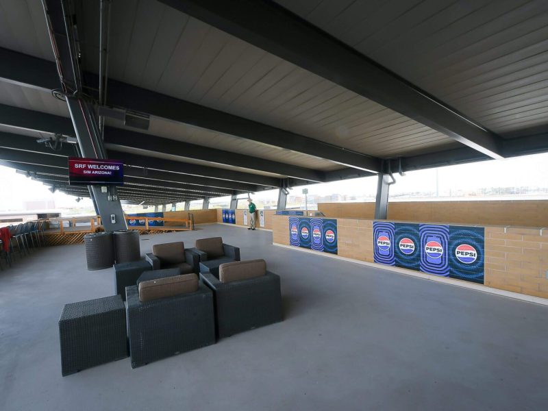 A spacious indoor seating area with multiple couches and tables.